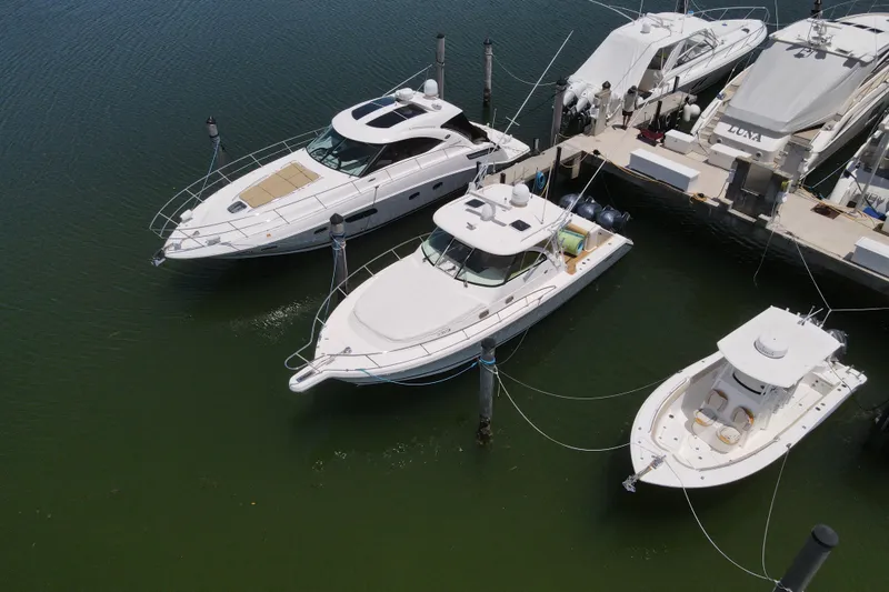 Slide: The Image of 2010 Pursuit OS 375 Offshore docked among luxury boats in a marina. - 3