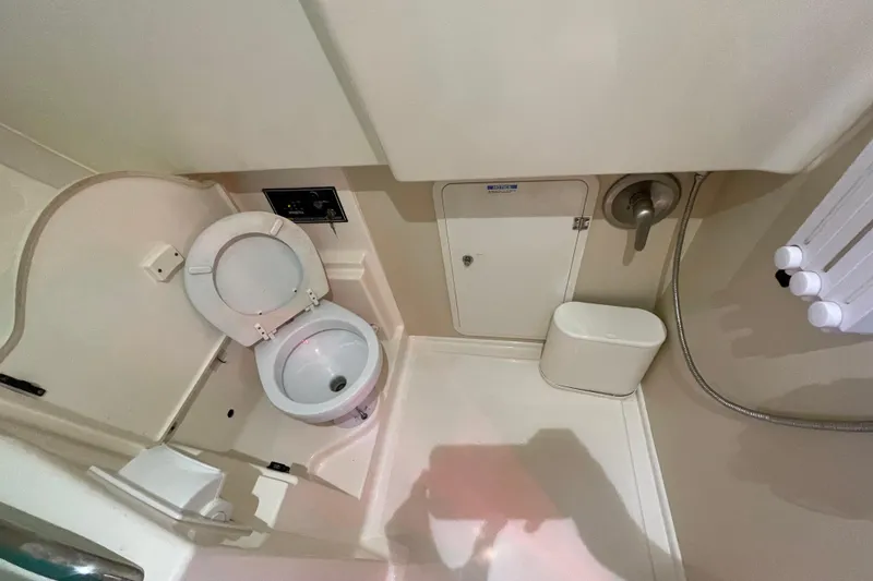 Slide: The Image of 2010 Pursuit OS 375 Offshore boat bathroom with toilet and shower amenities. - 35