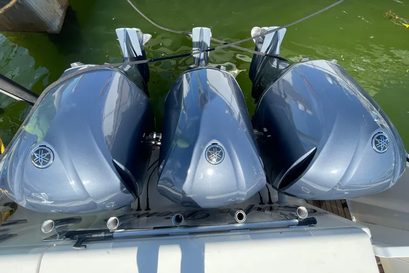 Slide: The Image of Triple Yamaha outboard engines on a 2010 Pursuit OS 375 Offshore boat. - 37