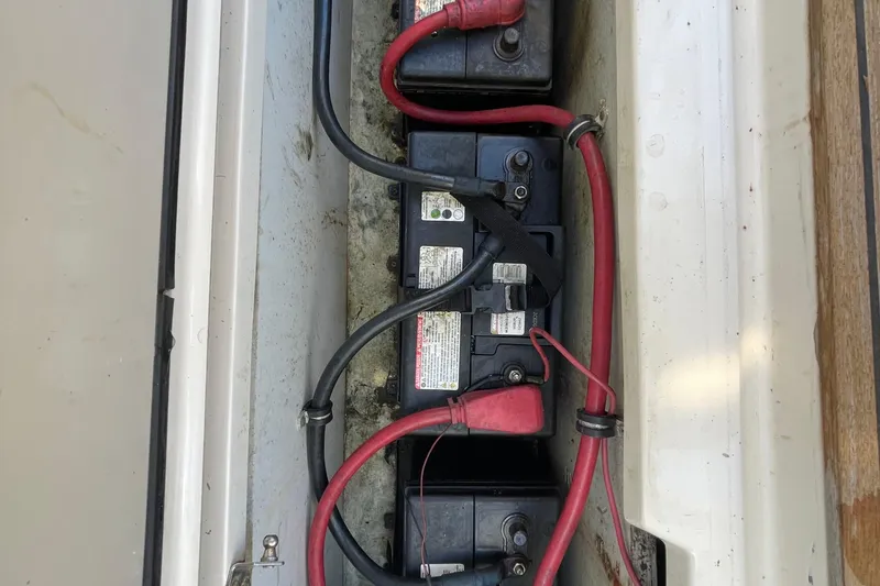 Slide: The Image of Battery compartment of 2010 Pursuit OS 375 Offshore boat with red and black cables. - 38