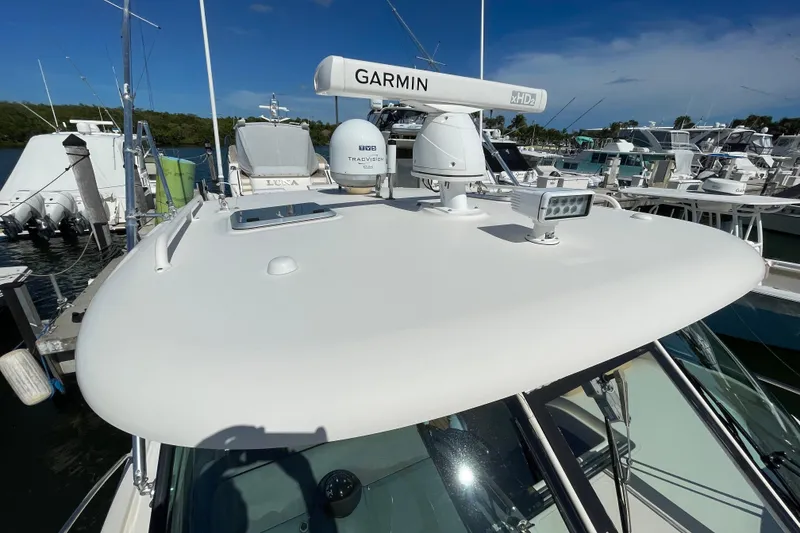 Slide: The Image of 2010 Pursuit OS 375 Offshore boat with Garmin radar and TracVision system at marina. - 40