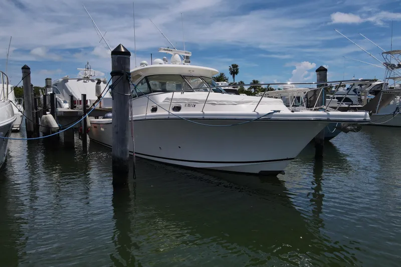 Slide: The Image of 2010 Pursuit OS 375 Offshore boat docked at marina under blue sky. - 8