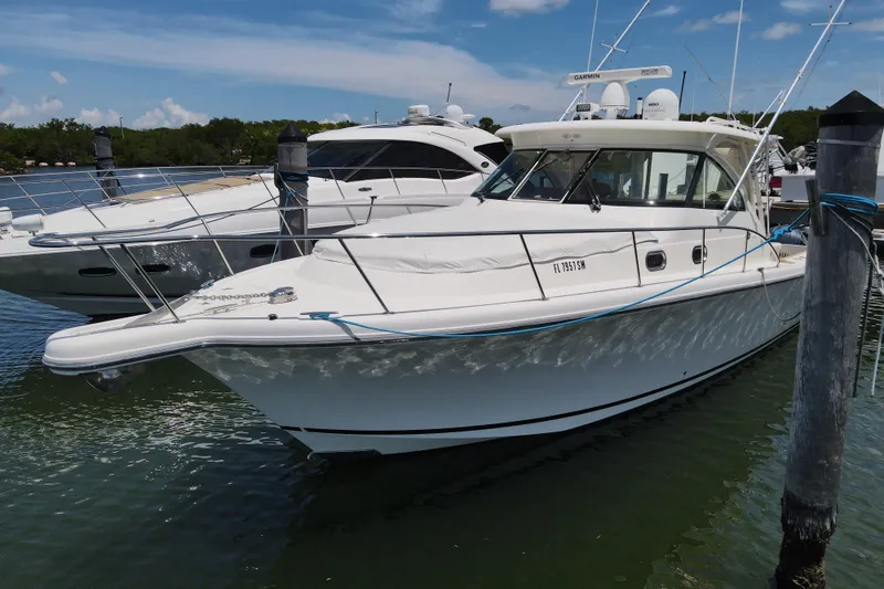 Slide: The Image of 2010 Pursuit OS 375 Offshore boat docked in marina, clear sky background. - 9