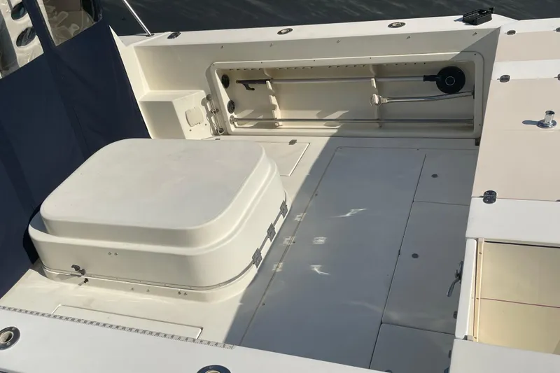 Slide: The Image of 1999 Albin 28 Tournament Express boat deck with storage compartments and seating. - 2