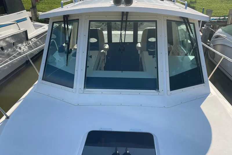 Slide: The Image of 1999 Albin 28 Tournament Express boat with a white cabin and large windows. - 6