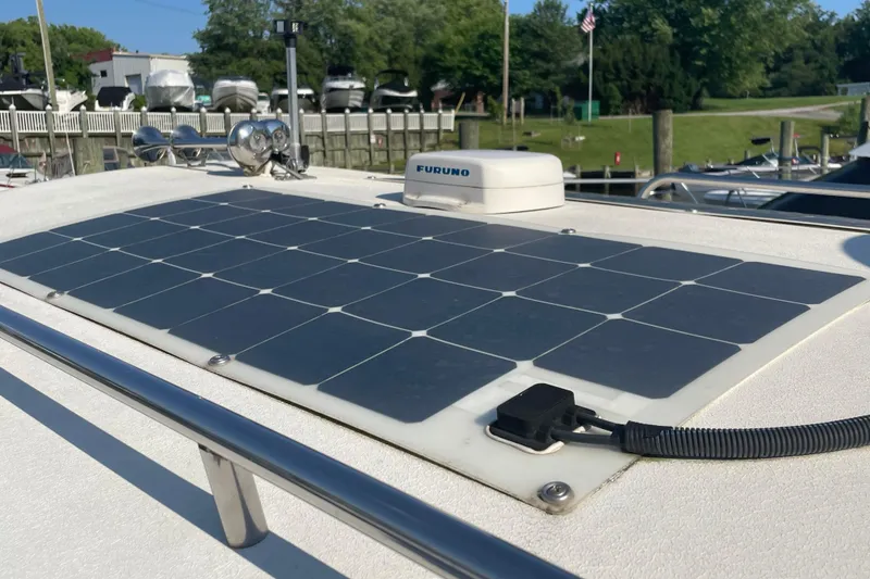 Slide: The Image of 1999 Albin 28 Tournament Express with solar panel on deck, docked at marina. - 9