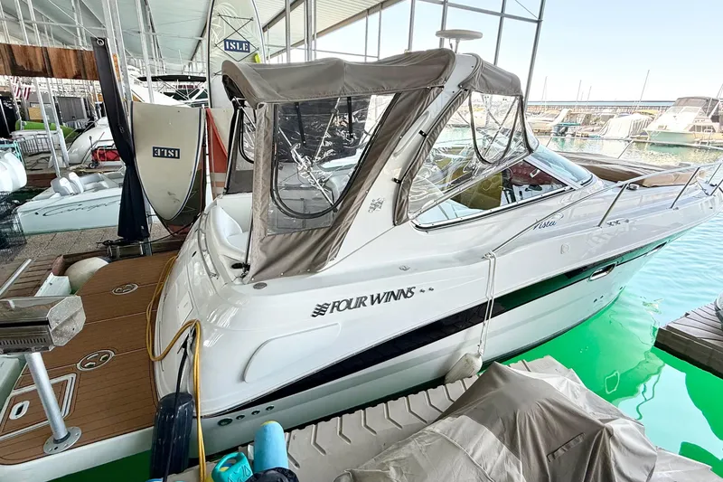 Slide: The Image of 2004 Four Winns 298 Vista boat docked in marina, covered with canopy. - 13