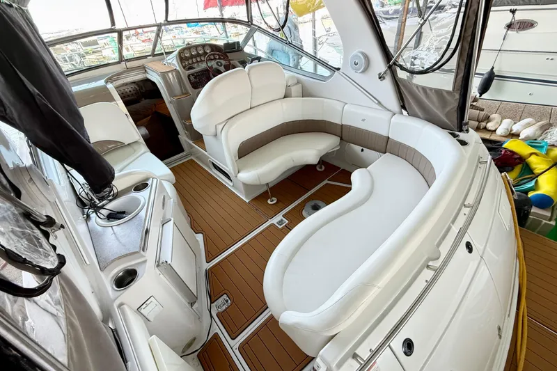 Slide: The Image of 2004 Four Winns 298 Vista boat interior with white seating and wood flooring. - 15