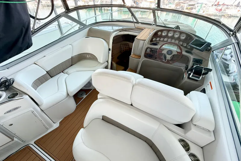 Slide: The Image of 2004 Four Winns 298 Vista boat interior with white seating and control panel. - 16