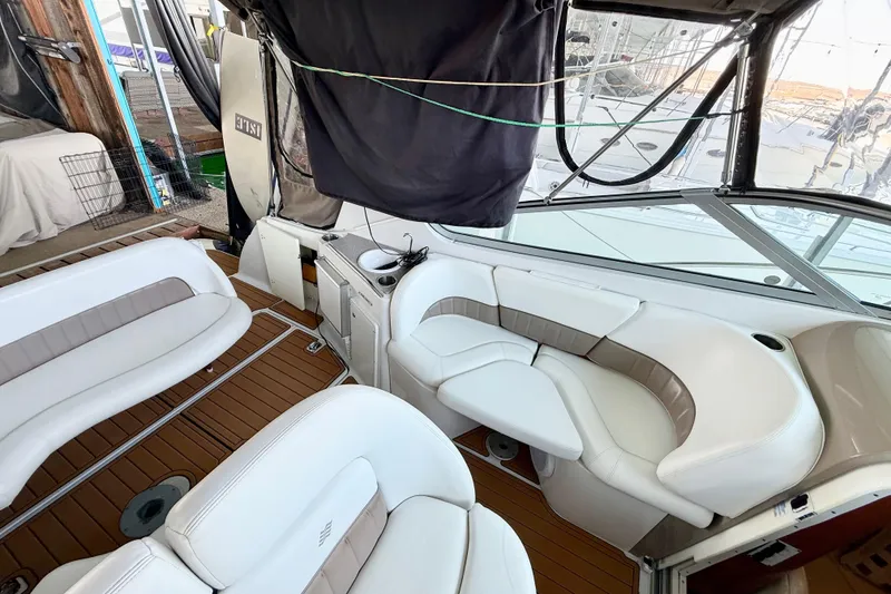 Slide: The Image of 2004 Four Winns 298 Vista boat interior with white seating and wood flooring. - 17