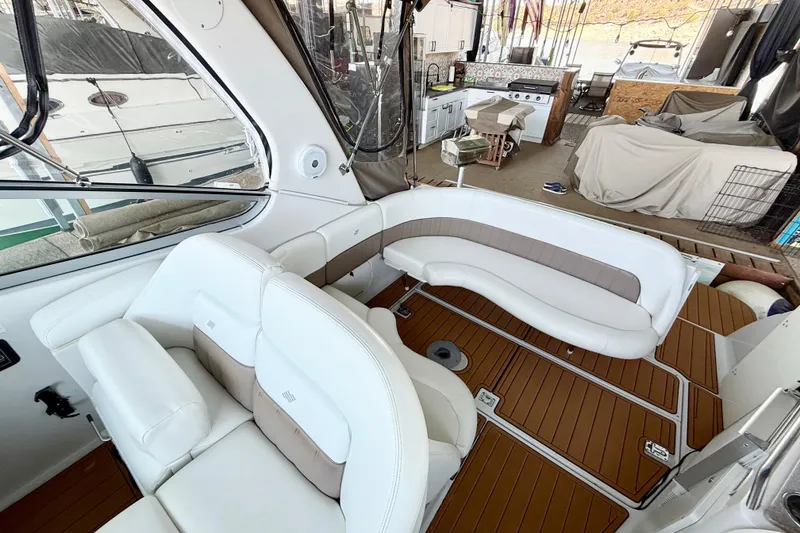 Slide: The Image of 2004 Four Winns 298 Vista boat interior with white seating and wood flooring. - 18