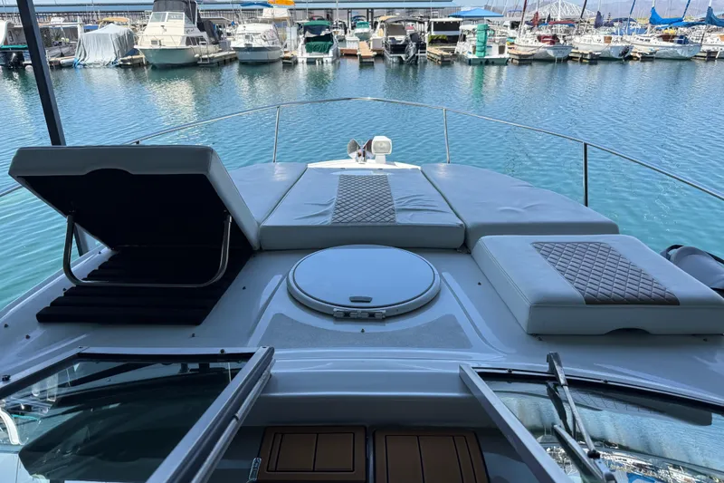 Slide: The Image of 2004 Four Winns 298 Vista boat with cushioned deck, docked in a marina. - 20