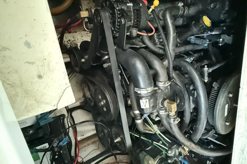 Slide: The Image of Engine compartment of a 2004 Four Winns 298 Vista boat, showing belts and hoses. - 39
