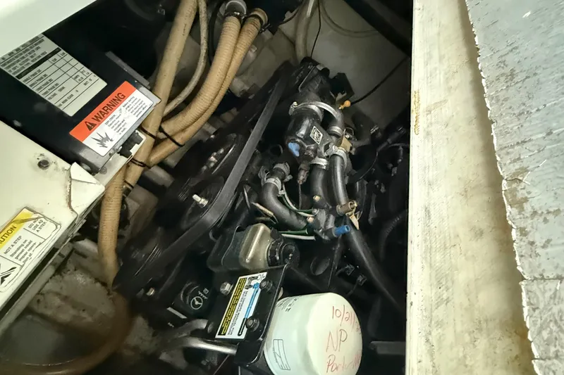 Slide: The Image of Engine compartment of a 2004 Four Winns 298 Vista boat, showing hoses and components. - 40