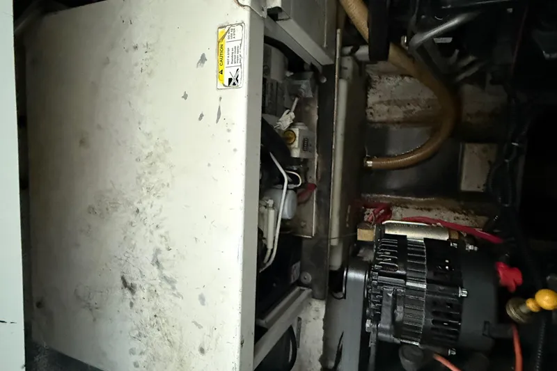 Slide: The Image of Engine compartment of a 2004 Four Winns 298 Vista boat, showing mechanical components. - 41