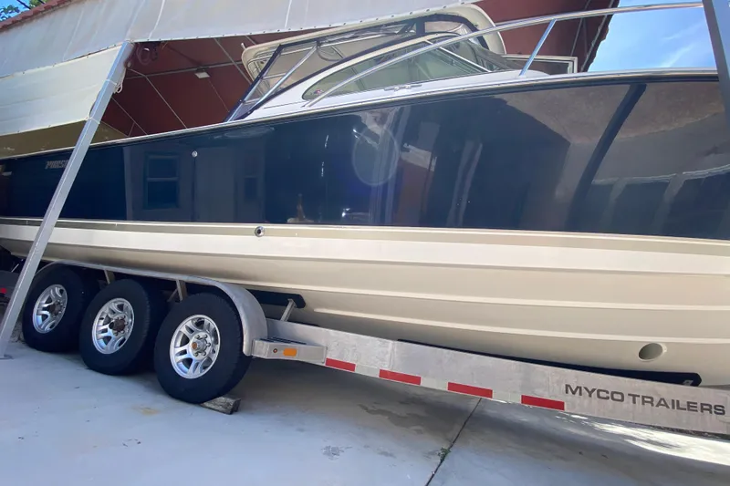 Slide: The Image of 2006 Pursuit 3480 Drummond Island Runner boat on Myco trailer in storage. - 13