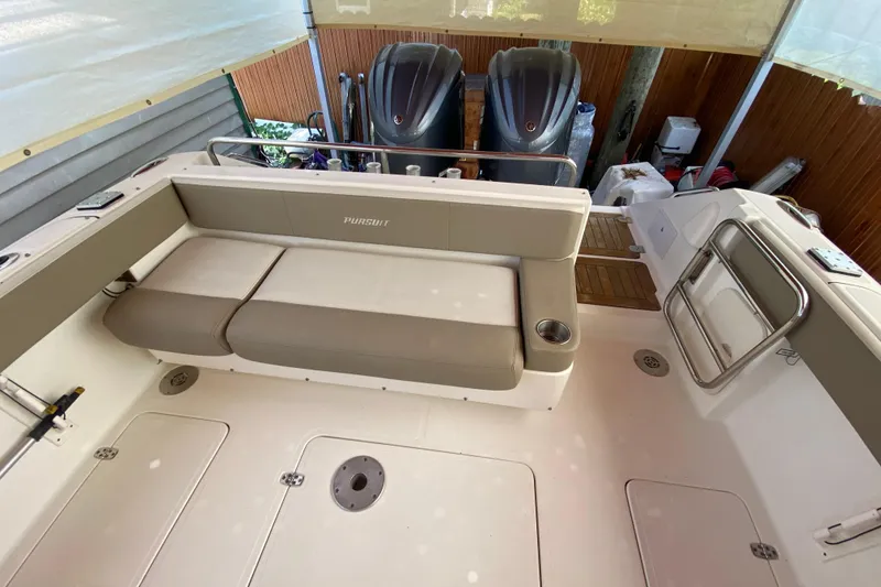 Slide: The Image of 2006 Pursuit 3480 Drummond Island Runner boat interior with seating and twin engines. - 18