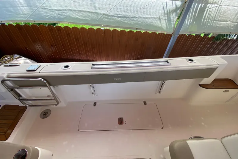 Slide: The Image of 2006 Pursuit 3480 Drummond Island Runner boat interior with seating and storage. - 19
