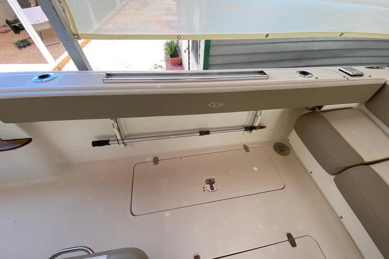 Slide: The Image of 2006 Pursuit 3480 Drummond Island Runner boat interior with seating and storage compartments. - 20