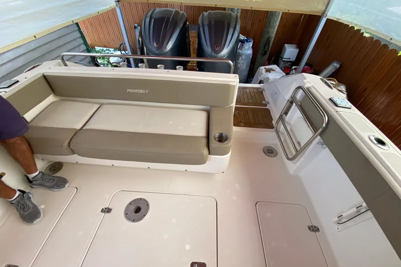 Slide: The Image of 2006 Pursuit 3480 Drummond Island Runner boat interior with seating and twin engines. - 21