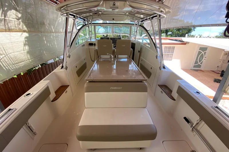 Slide: The Image of 2006 Pursuit 3480 Drummond Island Runner boat interior with seating and helm. - 22