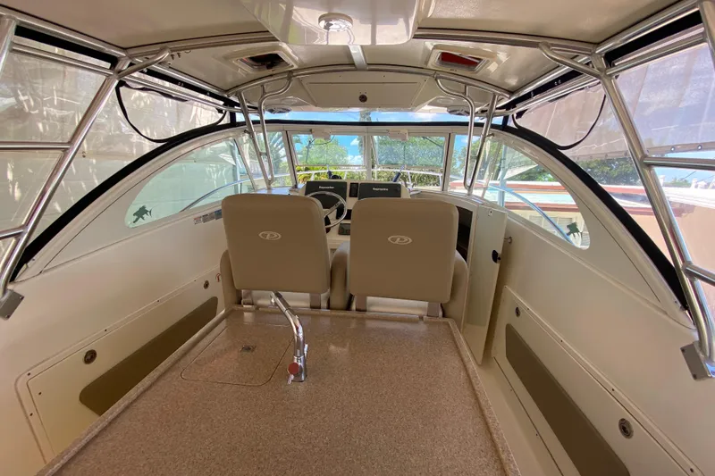 Slide: The Image of Interior of 2006 Pursuit 3480 Drummond Island Runner boat, featuring helm and seating area. - 24