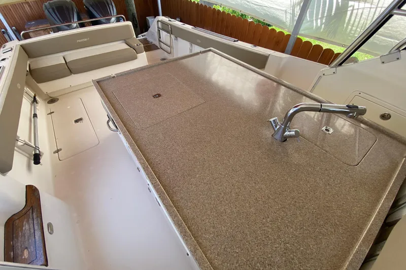 Slide: The Image of 2006 Pursuit 3480 Drummond Island Runner boat interior with seating and countertop. - 25