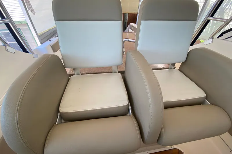 Slide: The Image of 2006 Pursuit 3480 Drummond Island Runner boat seats, beige and white upholstery. - 26