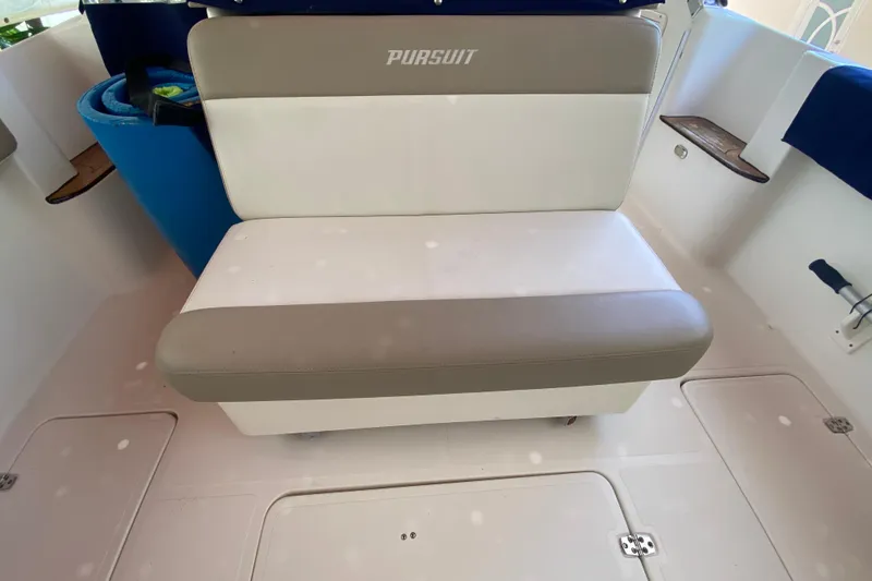 Slide: The Image of 2006 Pursuit 3480 Drummond Island Runner boat seat, white and gray upholstery. - 29