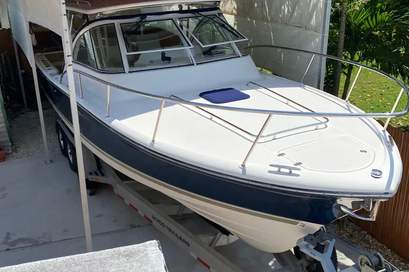 Slide: The Image of 2006 Pursuit 3480 Drummond Island Runner boat on trailer, parked outdoors. - 3