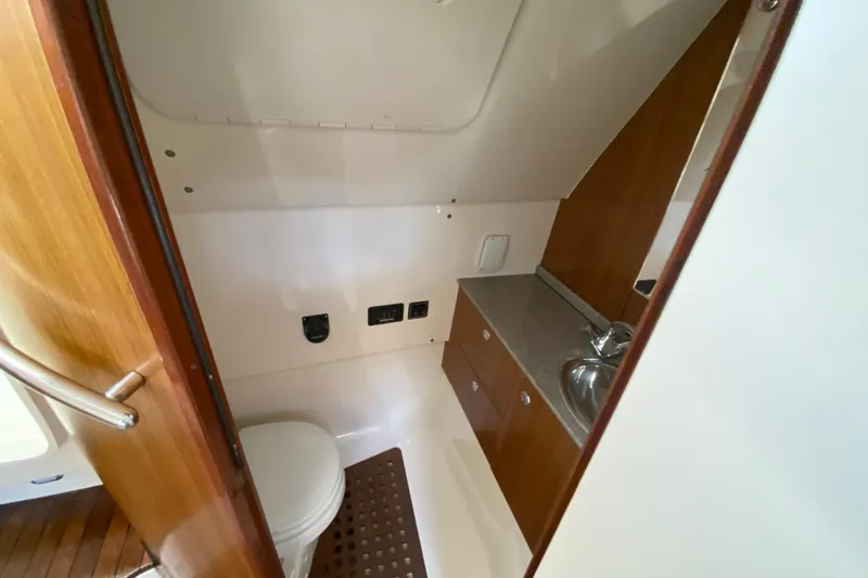 Slide: The Image of 2006 Pursuit 3480 Drummond Island Runner boat bathroom with sink and toilet. - 33