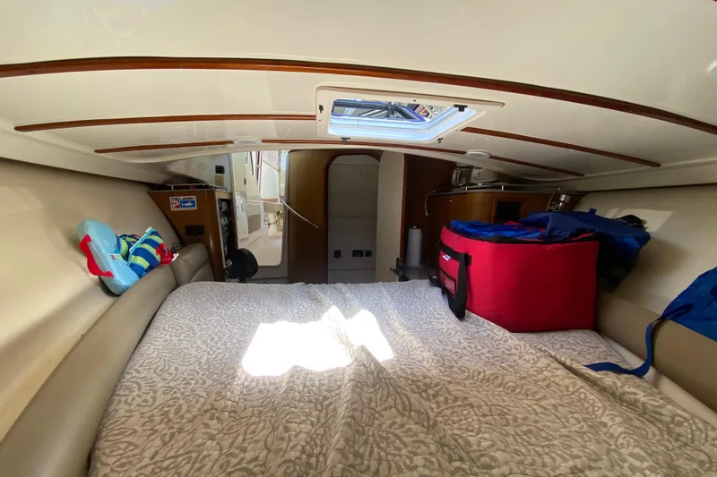 Slide: The Image of Interior cabin of 2006 Pursuit 3480 Drummond Island Runner, featuring cozy bedding and storage. - 38