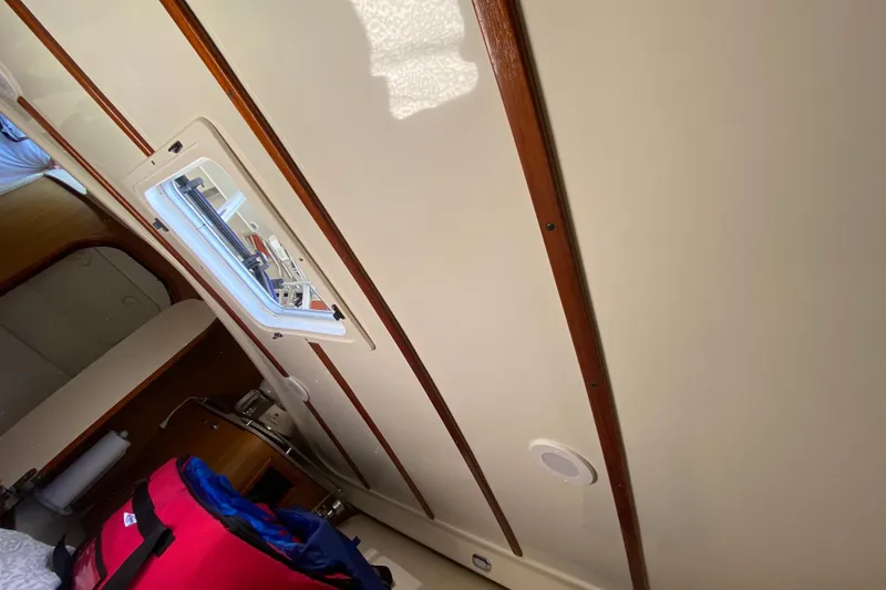 Slide: The Image of Interior of 2006 Pursuit 3480 Drummond Island Runner boat, featuring wood accents and a window. - 39