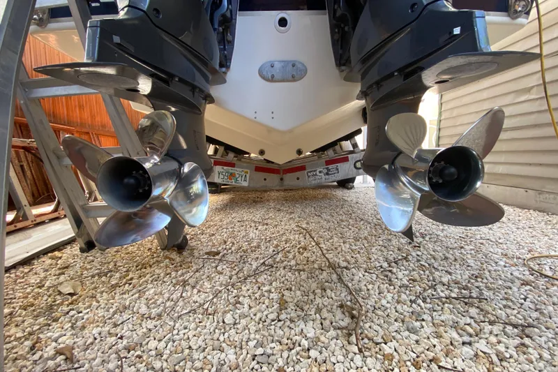 Slide: The Image of 2006 Pursuit 3480 Drummond Island Runner boat with dual propellers on gravel. - 42