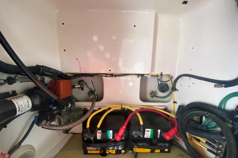 Slide: The Image of Engine compartment of a 2006 Pursuit 3480 Drummond Island Runner with visible wiring and batteries. - 44