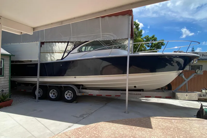 Slide: The Image of 2006 Pursuit 3480 Drummond Island Runner boat on trailer under canopy. - 5