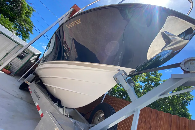 Slide: The Image of 2006 Pursuit 3480 Drummond Island Runner boat on trailer, sunny day, blue sky. - 9