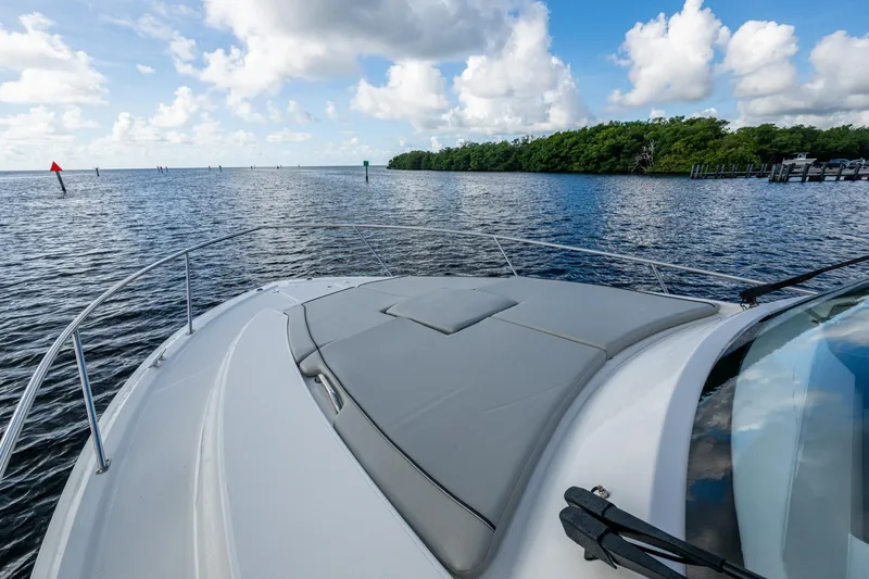 Slide: The Image of 2022 Pursuit OS 355 Offshore boat cruising on a calm, scenic waterway. - 12