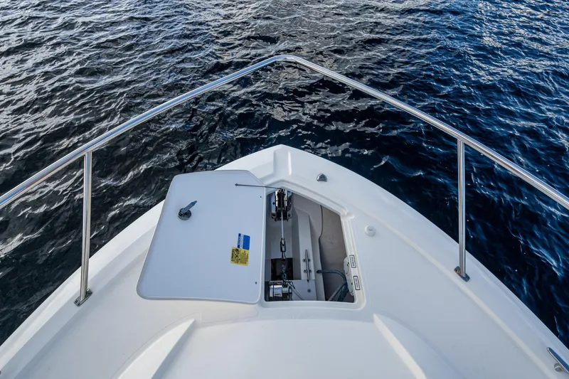 Slide: The Image of Bow view of 2022 Pursuit OS 355 Offshore boat on water. - 13