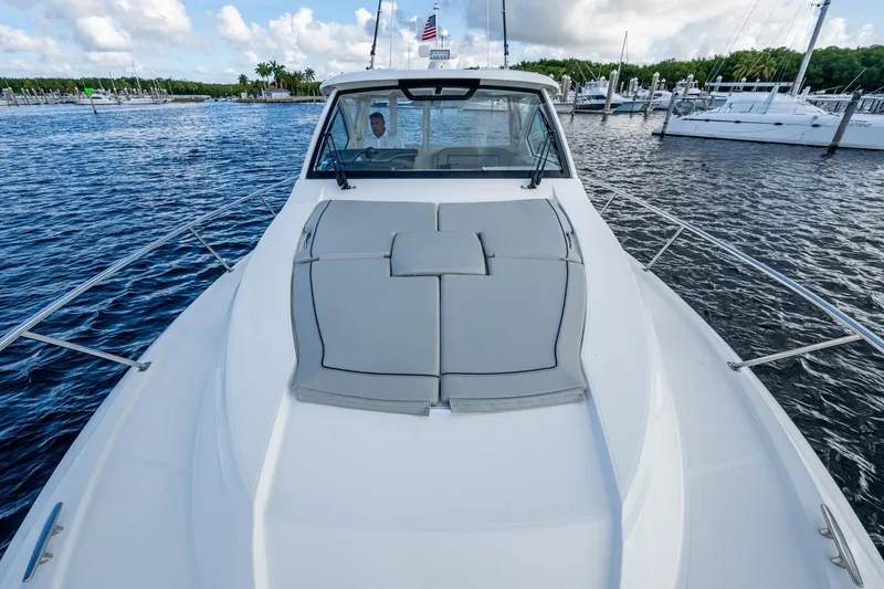 Slide: The Image of 2022 Pursuit OS 355 Offshore boat on water, featuring spacious deck and sleek design. - 14