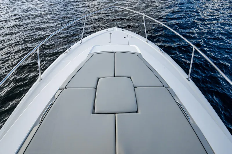 Slide: The Image of 2022 Pursuit OS 355 Offshore boat deck with cushioned seating, surrounded by water. - 15
