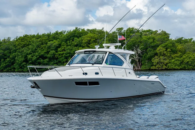 Slide: The Image of 2022 Pursuit OS 355 Offshore boat cruising on a scenic waterway. - 2