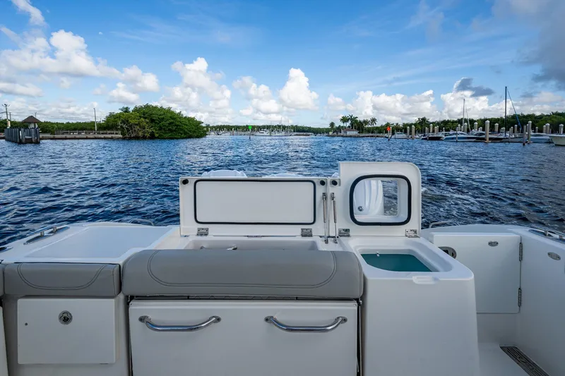 Slide: The Image of 2022 Pursuit OS 355 Offshore boat interior with scenic marina view. - 20