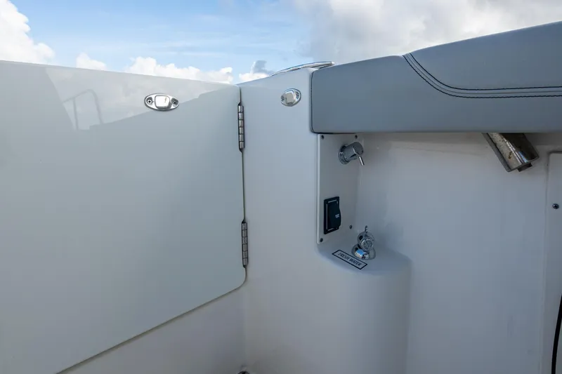 Slide: The Image of 2022 Pursuit OS 355 Offshore boat interior detail with fresh water access and sleek design. - 21
