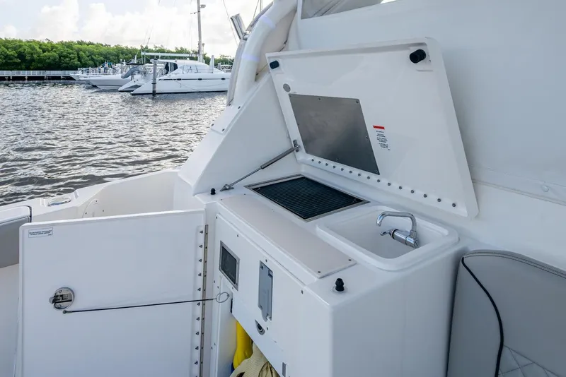 Slide: The Image of 2022 Pursuit OS 355 Offshore boat with outdoor sink and grill station. - 22