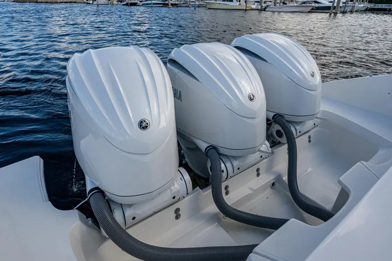 Slide: The Image of Triple Yamaha outboard engines on a 2022 Pursuit OS 355 Offshore boat. - 29