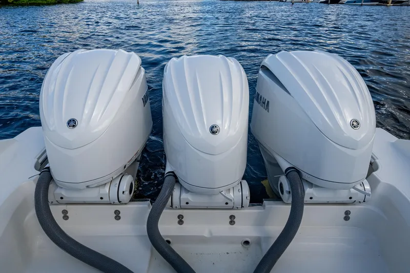 Slide: The Image of Triple Yamaha outboard engines on a 2022 Pursuit OS 355 Offshore boat. - 30