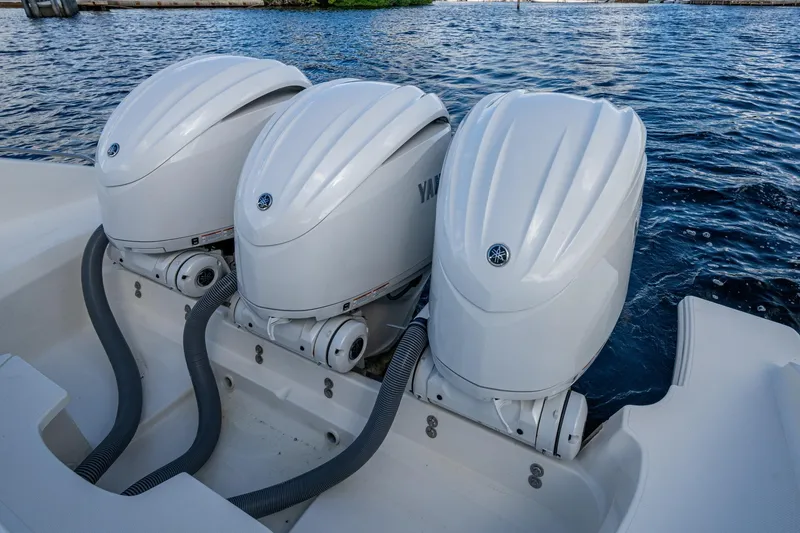 Slide: The Image of Triple Yamaha outboard engines on a 2022 Pursuit OS 355 Offshore boat. - 31
