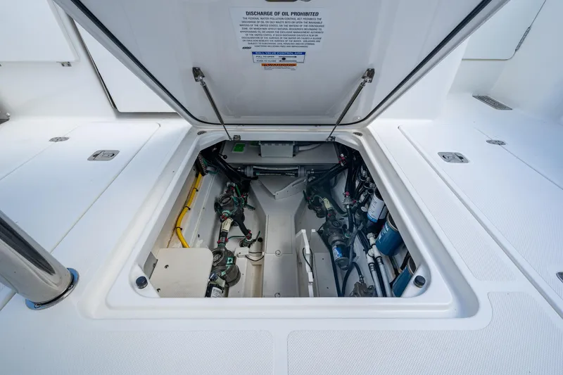 Slide: The Image of 2022 Pursuit OS 355 Offshore engine compartment, showcasing clean and organized mechanical components. - 32