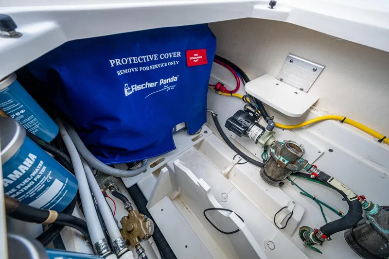 Slide: The Image of Engine compartment of 2022 Pursuit OS 355 Offshore with Fischer Panda cover and Yamaha filters. - 33